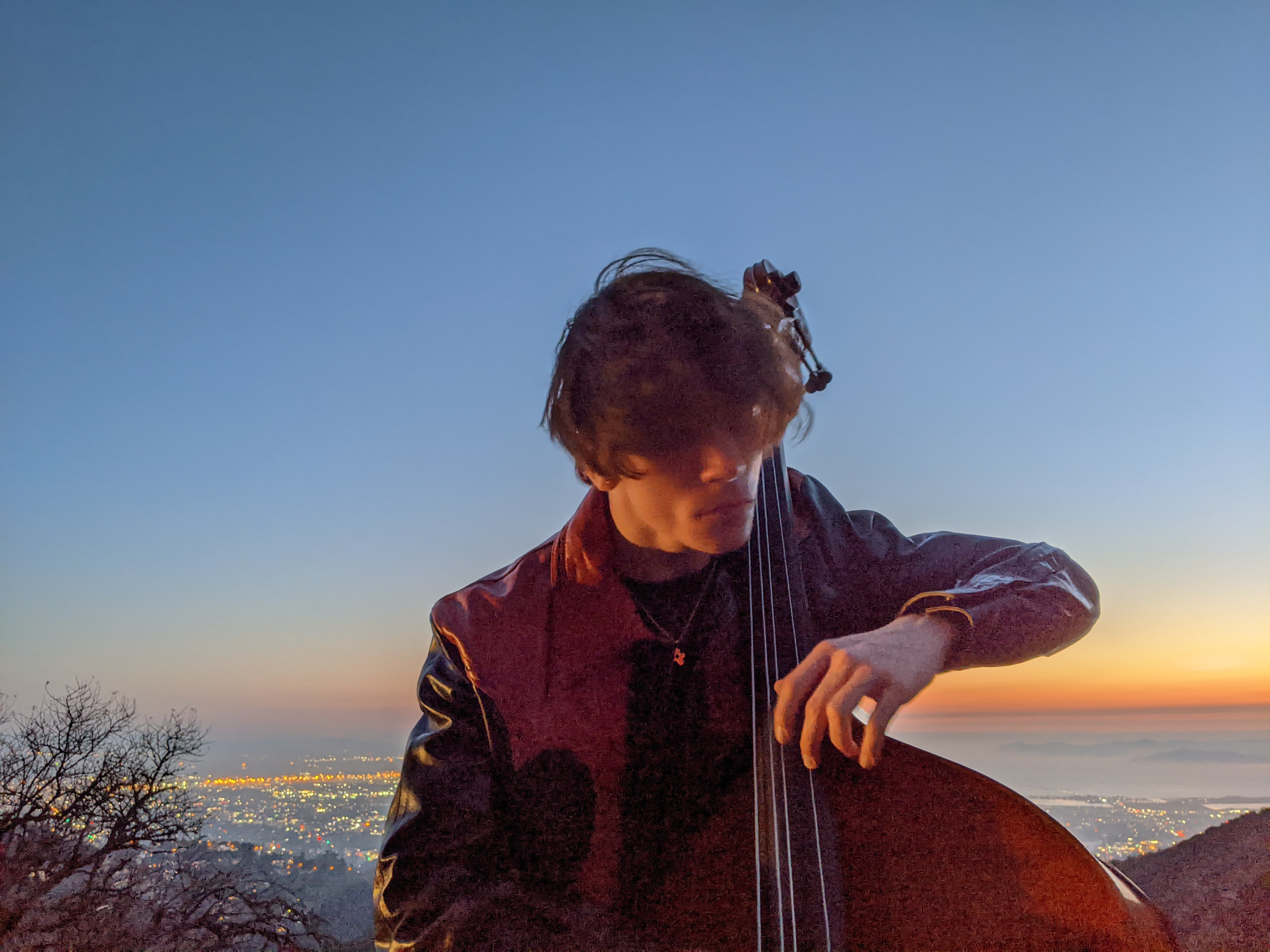 Rocco playing upright bass outdoors at night